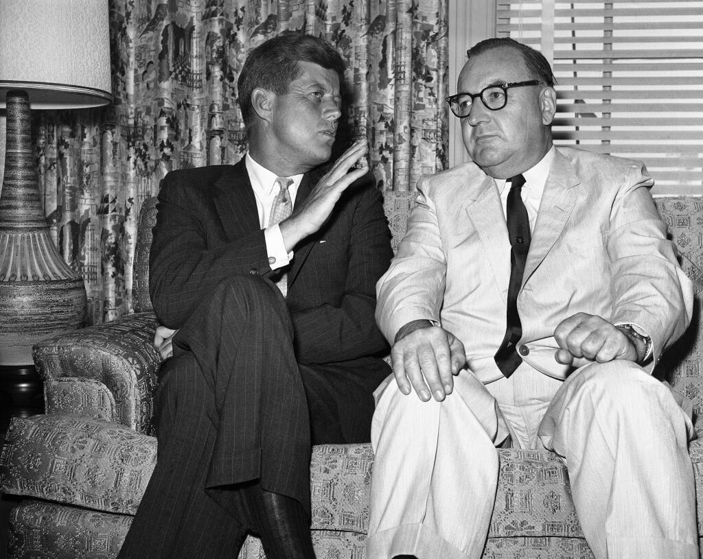 FILE - In this July 10, 1960, file photo, Sen. John F. Kennedy of Massachusetts gestures during his meeting with California Gov. Edmund G. (Pat) Brown in Los Angeles. Former California Gov. Jerry Brown wants to know who is trying to sell his father's memorabilia related to the assassination of President John F. Kennedy. Private letters and other items that had belonged to Edmund G. 'Pat' Brown when he was California governor are being offered by the auction house Sotheby's, which estimates the value at $20,000 to $30,000. (AP Photo, File)