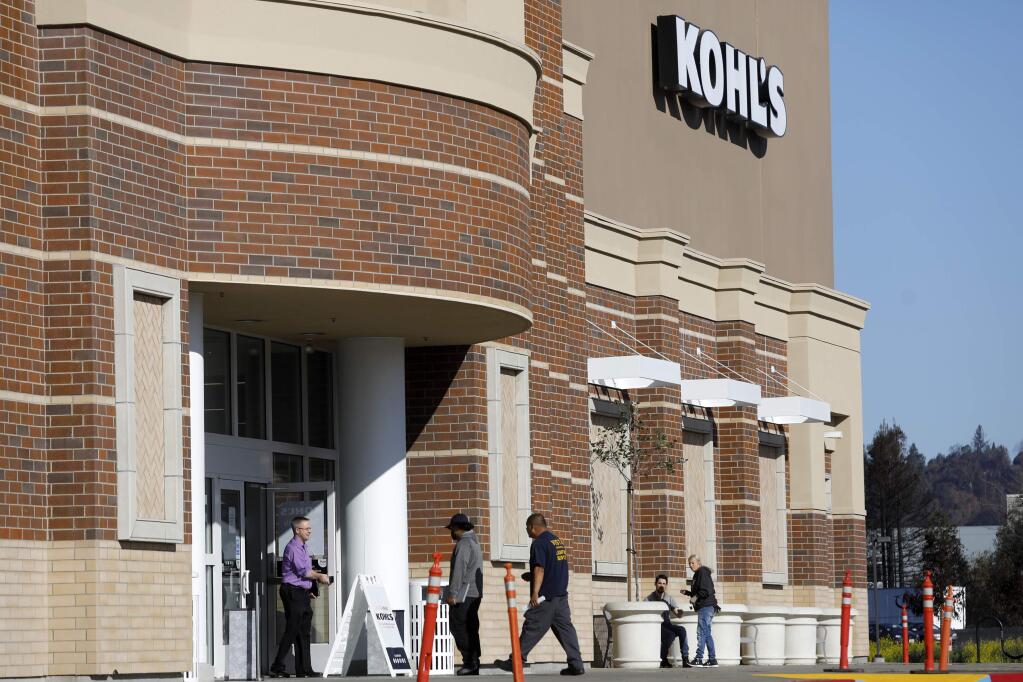 Lighting contractors walk into Kohl's as work continues to repair the interior after significant smoke damage was incurred during the Tubbs fire. Photo taken in Santa Rosa, on Wednesday, February 21, 2018. (BETH SCHLANKER/ The Press Democrat)