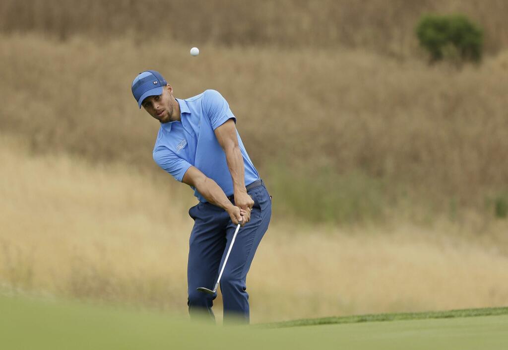 Golden State Warriors player Stephen Curry chips the ball onto the ninth green during the Web.com Tour's Ellie Mae Classic golf tournament Thursday, Aug. 3, 2017, in Hayward. Curry shot a 4-over-par 74. (AP Photo/Eric Risberg)