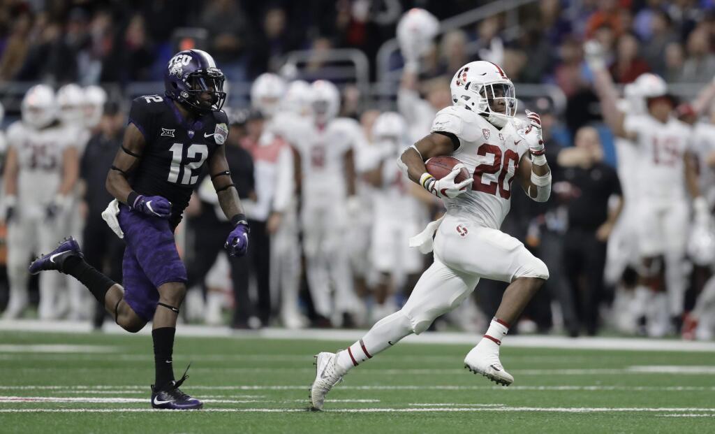 Stanford running back Bryce Love is pursued by TCU cornerback Jeff Gladney as he runs for a touchdown during the second half of the Alamo Bowl, Thursday, Dec. 28, 2017, in San Antonio. (AP Photo/Eric Gay)