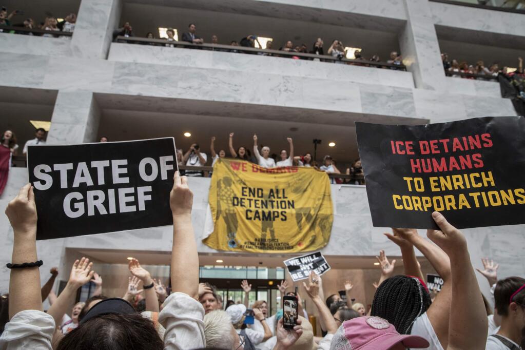 Hundreds of activists protest the Trump administration's approach to illegal border crossings and separation of children from immigrant parents, in the Hart Senate Office Building on Capitol Hill in Washington, Thursday, June 28, 2018. (AP Photo/J. Scott Applewhite)