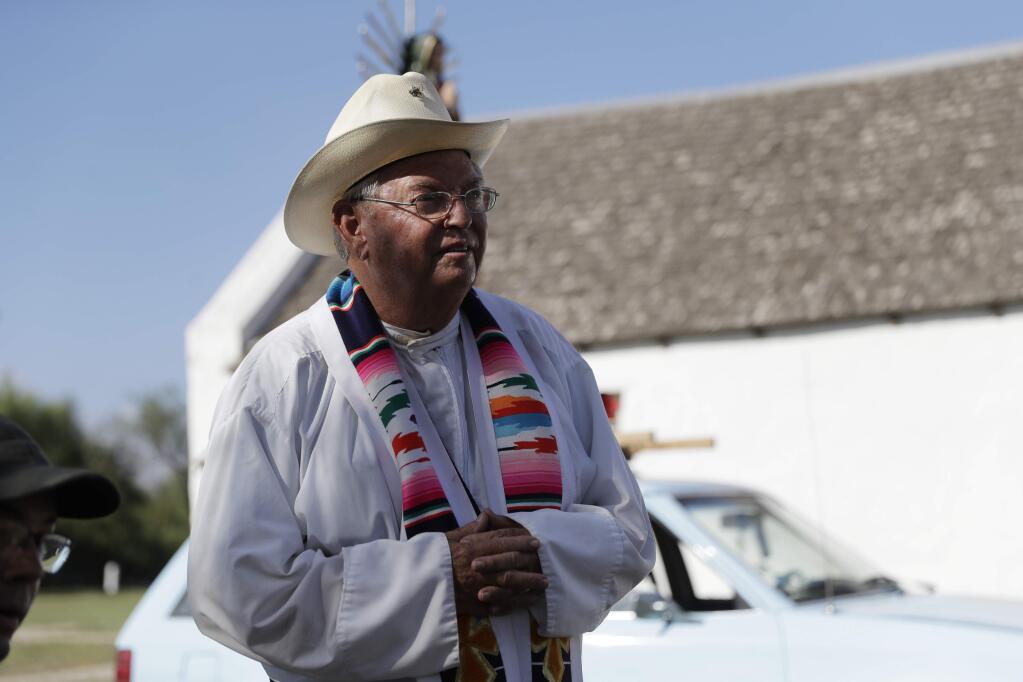 In this Aug. 12, 2017, photo, Father Roy Snipes after he lead a procession to the La Lomita Chapel along a levee toward the Rio Grande to oppose the wall the U.S. government wants to build on the river separating Texas and Mexico in Mission, Texas. Rather than surrender their land to the federal government, some property owners on the Texas border are digging in to fight President Donald Trump's border wall. (AP Photo/Eric Gay)