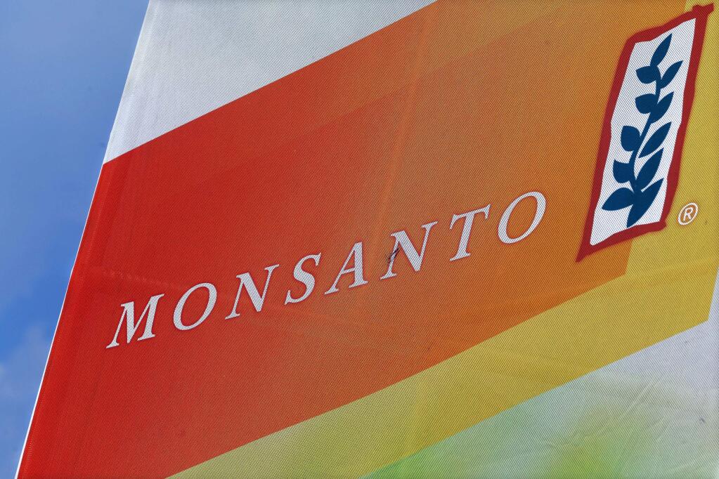 FILE - This Aug. 31, 2015, file photo, shows the Monsanto logo on display at the Farm Progress Show in Decatur, Ill. German drug and farm chemical company Bayer AG said it has signed a deal Wednesday, Sept. 14, 2016, to acquire seed and weed-killer company Monsanto for about $66 billion in cash. (AP Photo/Seth Perlman, File)