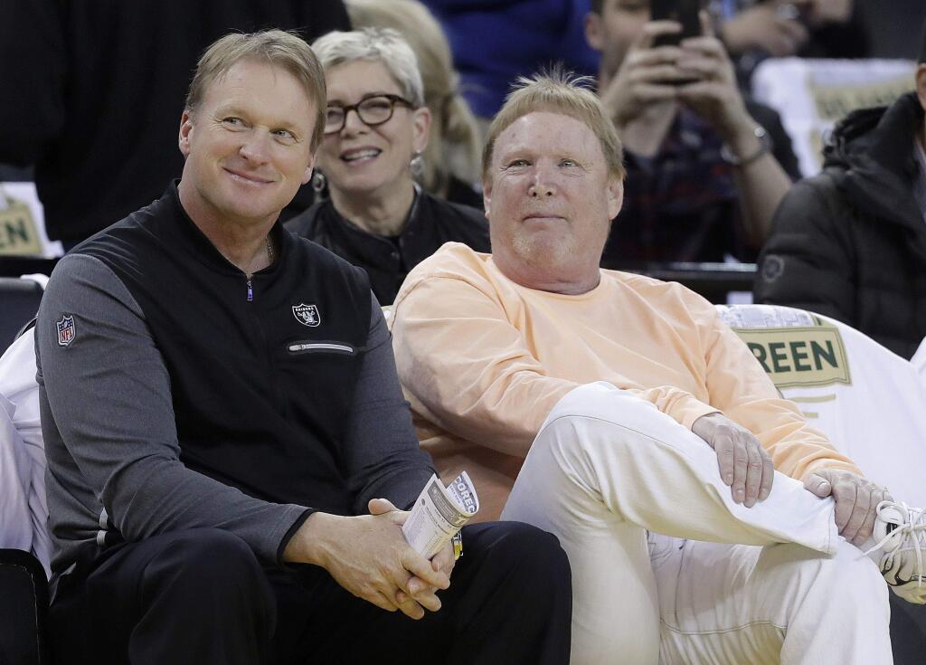Oakland Raiders football coach Jon Gruden, left, and Raiders owner Mark Davis at an NBA basketball game between the Golden State Warriors and the San Antonio Spurs in Oakland, Calif., Thursday, March 8, 2018. (AP Photo/Jeff Chiu)