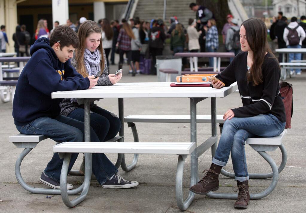 Jerry Schumikowski, Megan Buck, left, and Sabrina Paredes spend time on their smart phines during turtorial at petaluma High School on Tuesday, February 17, 2015. (SCOTT MANCHESTER/ARGUS-COURIER STAFF)