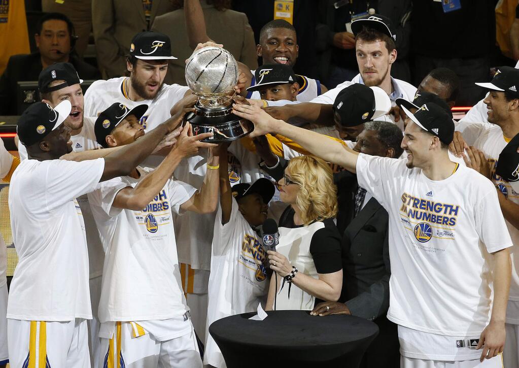 Golden State Warriors players celebrate after Game 5 of the NBA basketball Western Conference finals against the Houston Rockets in Oakland, Calif., Wednesday, May 27, 2015. The Warriors won 104-90 and advanced to the NBA Finals. (AP Photo/Tony Avelar)