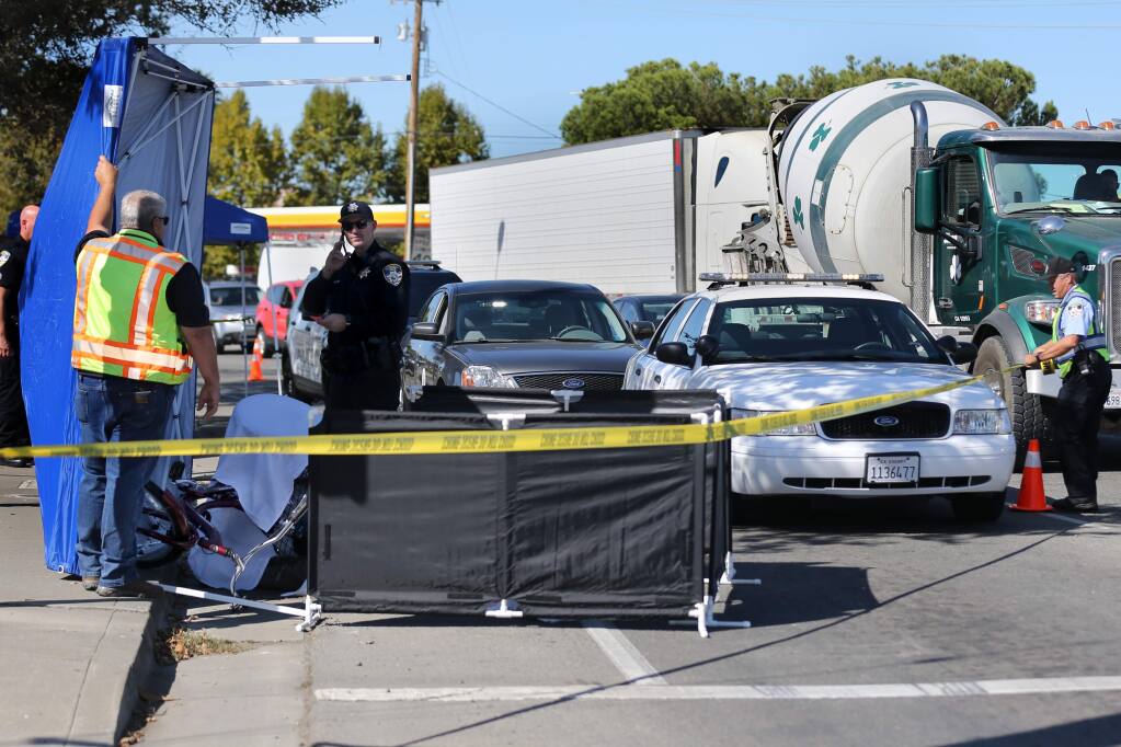 Petaluma police work at the scene of a fatal adult tricycle accident on Lakeville St. in front of In-N-Out Burger in Petaluma on Wednesday, October 23, 2019. (BETH SCHLANKER/ The Press Democrat)