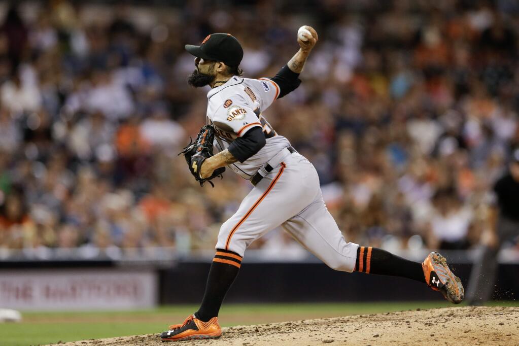 San Francisco Giants relief pitcher Sergio Romo works against a San Diego Padres batter during the eighth inning of a baseball game Thursday, Sept. 24, 2015, in San Diego. The Padres won 5-4. (AP Photo/Gregory Bull)