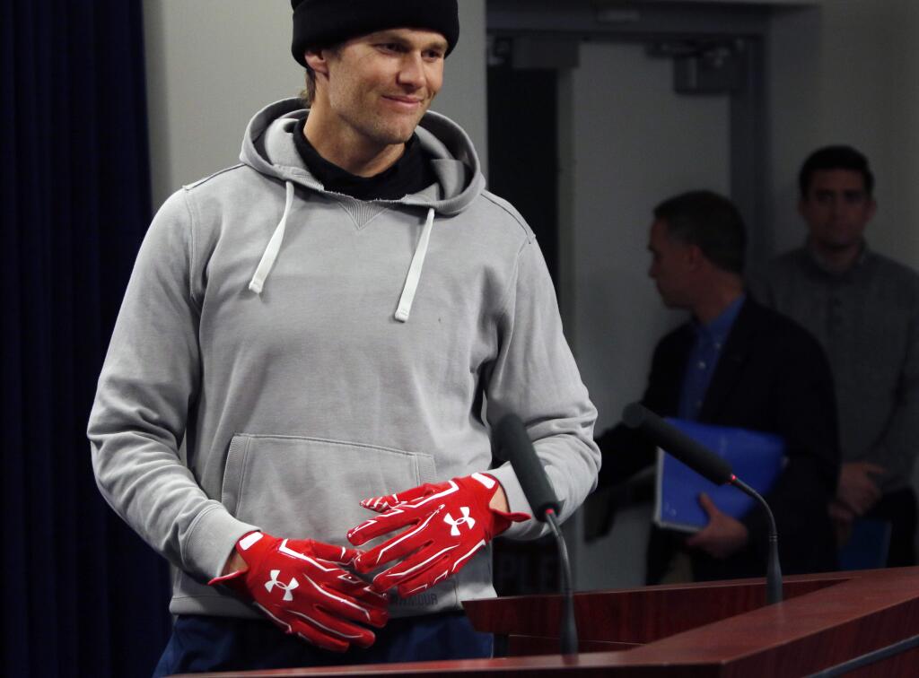 New England Patriots quarterback Tom Brady wears gloves as he arrives to speak to the media, Friday, Jan. 19, 2018, in Foxborough, Mass. The Patriots host the Jacksonville Jaguars in the AFC championship on Sunday in Foxborough.(AP Photo/Bill Sikes)