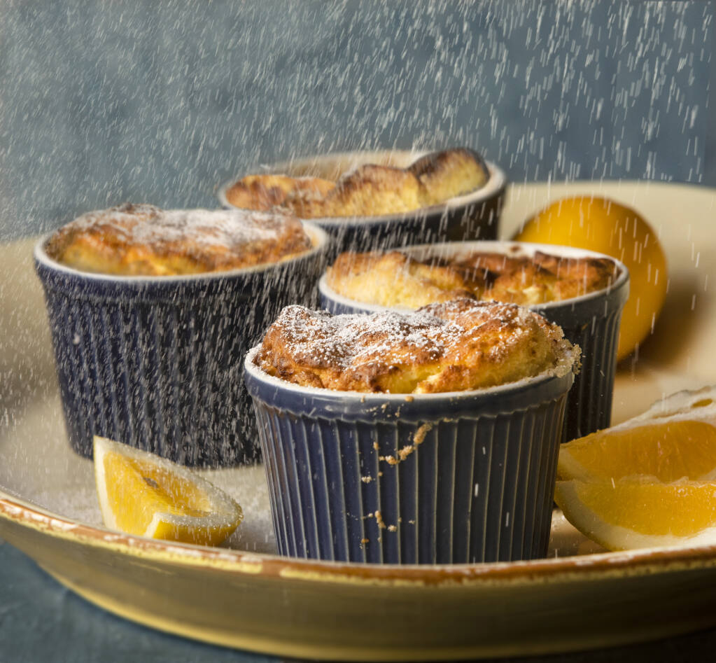Meyer Lemon Soufflés dusted with powdered sugar by chef John Ash take advantage of the spring bumper crop of Meyer lemons, which tolerate cold and grow well on the North Coast. (John Burgess/The Press Democrat)