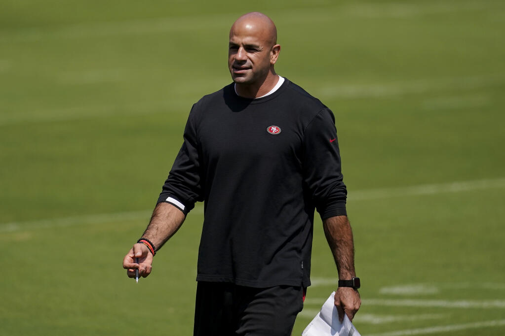 FILE - In this Sept. 2, 2020, file photo, San Francisco 49ers defensive coordinator Robert Saleh watches during the NFL football team's practice in Santa Clara, Calif. Saleh, the New York Jets' new head coach, has families in neighborhoods all across the country celebrating the first known Muslim American to hold that position in NFL history. That's a source of great pride for a community that has been generally underrepresented in the league's on-field leadership roles. (AP Photo/Jeff Chiu, Pool, File)