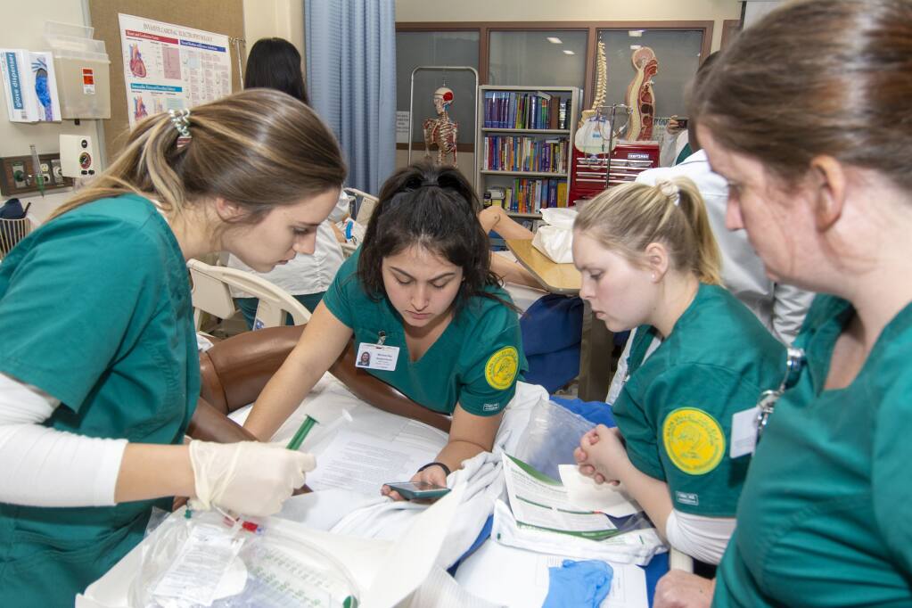Napa Valley College nursing students compare notes as they learn how to draw blood. (Photo courtesy Napa Valley College)