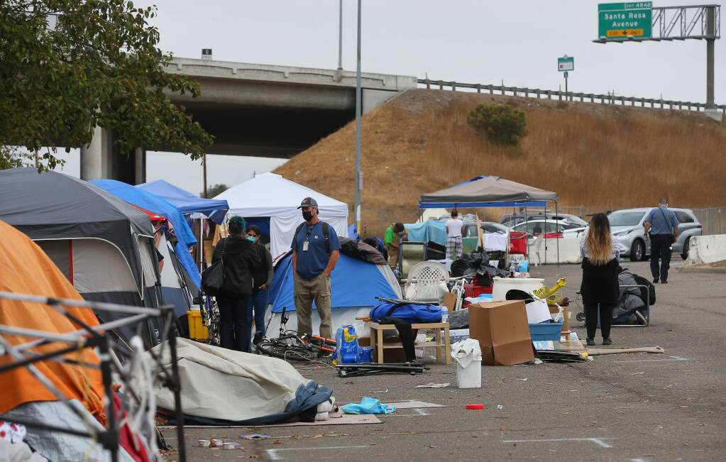 Rohnert Park personnel clear a homeless encampment at the Roberts Lake park and ride lot on Sept. 10. (CHRISTOPHER CHUNG / The Press Democrat)