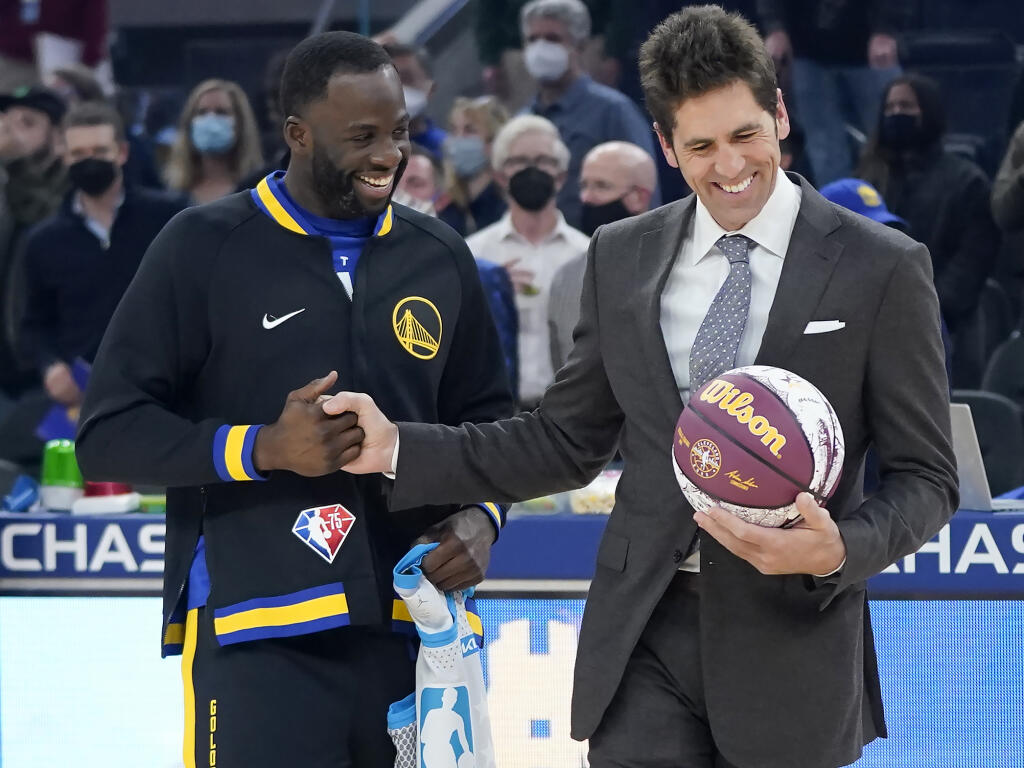 Warriors forward Draymond Green, left, greets general manager Bob Myers before a game last year against the Denver Nuggets in San Francisco. (Jeff Chiu / ASSOCIATED PRESS)