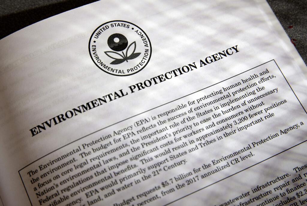 FILE - In this March 16, 2017, file photo, proposals for the Environmental Protection Agency (EPA) in President Donald Trump's first budget are displayed at the Government Printing Office in Washington. President Donald Trump will sign an executive order on March 29 that will suspend, rescind, or flag for review more than half-a-dozen measures that were part of former President Barack Obama's sweeping plan to curb global warming. (AP Photo/J. Scott Applewhite, file)
