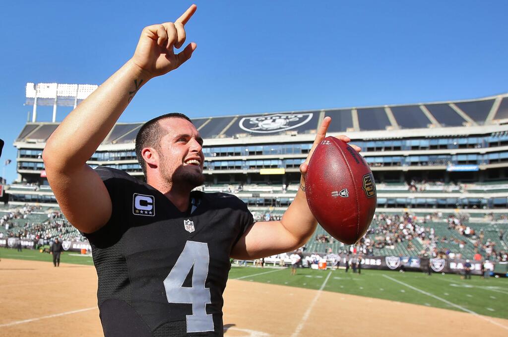 Oakland Raiders quarterback Derek Carr acknowledges the fans after leading his team to victory over the Baltimore Ravens in Oakland on Sunday, September 20, 2015. The Raiders defeated the Ravens 37-33.(Christopher Chung/ The Press Democrat)