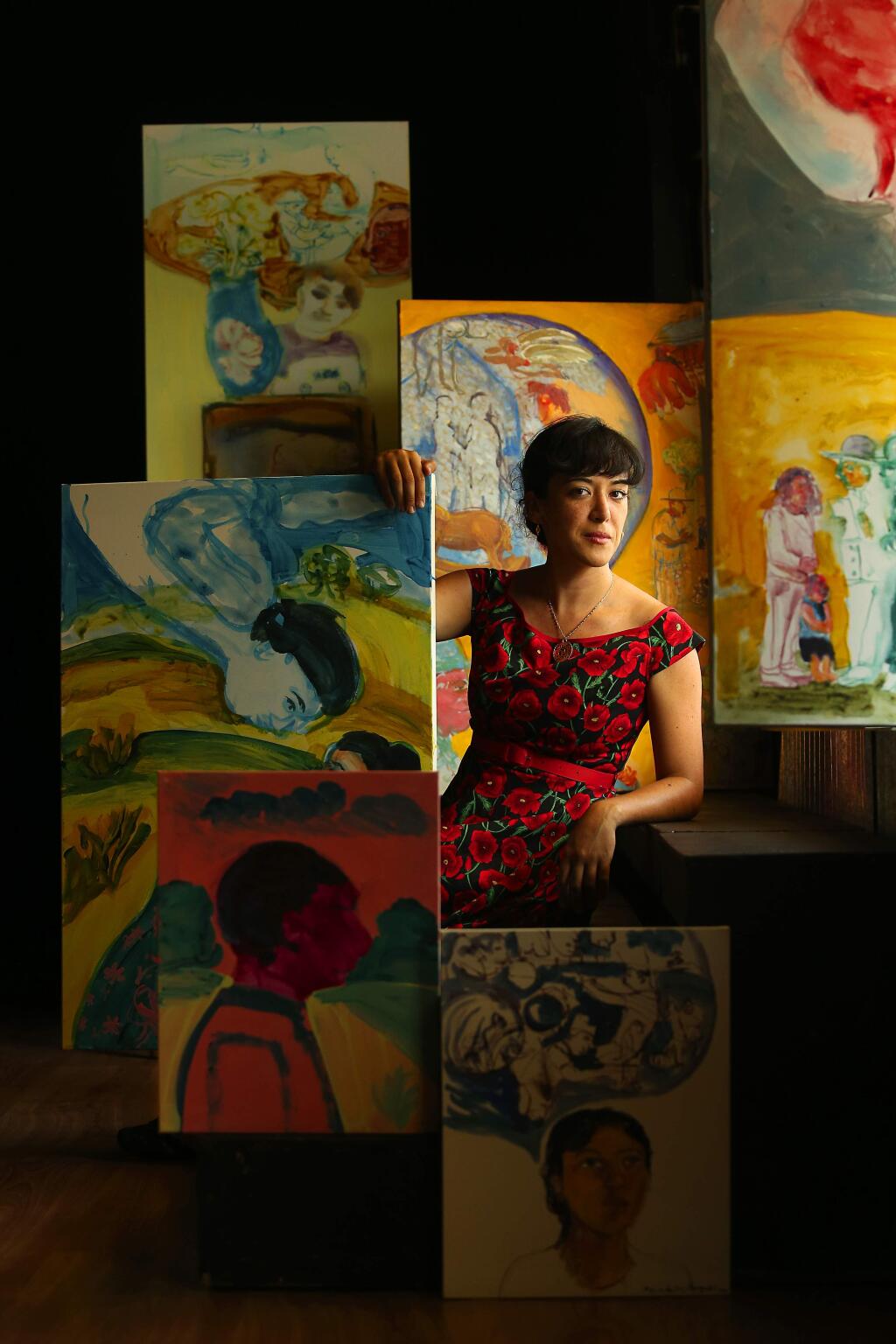 Latina artist Maria de Los Angeles with some of her work for a show at the Imaginist Theater in Santa Rosa. (JOHN BURGESS / The Press Democrat)