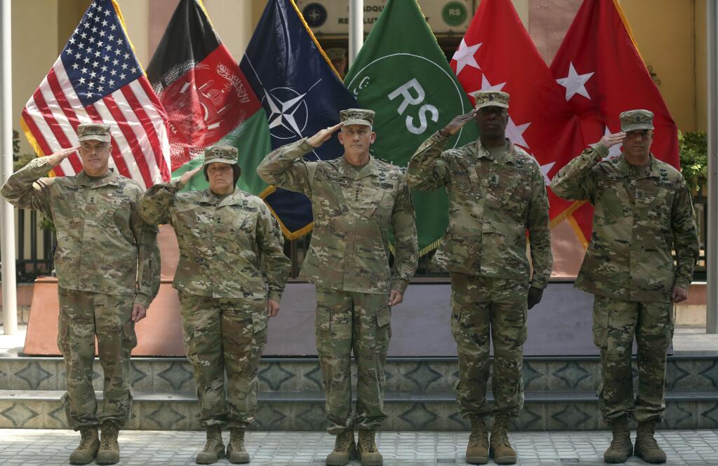FILE - In this Saturday, July 15, 2017 file photo, Army Gen. John W. Nicholson, center, commander of the Resolute Support mission and U.S. forces in Afghanistan; outgoing Maj. Gen. Richard G. Kaiser, left, and incoming Maj. Gen. Robin L. Fontes, second left, salute during a change of command ceremony at Resolute Support headquarters, in Kabul, Afghanistan. (AP Photos/Massoud Hossaini)