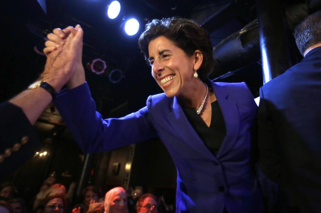 STEVE SENNE / Associated PressRhode Island Democratic gubernatorial nominee Gina Raimondo shakes hands with a supporter as she takes the stage at a primary election night party this week.