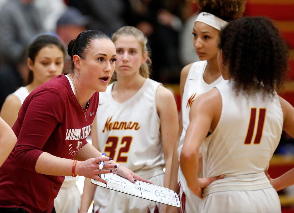 Cardinal Newman head coach Monica Mertle talks to her players during a timeout in the second half of the NCS Open Division playoff game against Heritage High School in Santa Rosa on Thursday, Feb. 20, 2020. (Alvin Jornada / The Press Democrat)