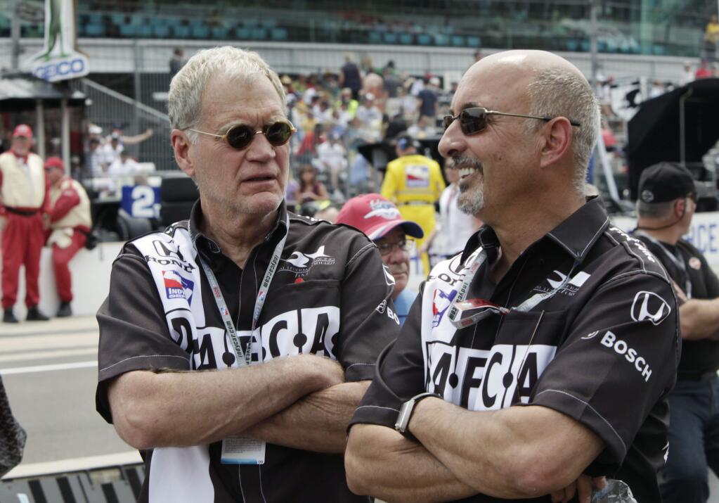 FILE - In this May 24, 2009, file photo, David Letterman, left, and Bobby Rahal, car owners for driver Oriol Servia, of Spain, talk before the 93rd running of the Indianapolis 500 auto race at the Indianapolis Motor Speedway in Indianapolis. Letterman expressed his grief in a telephone interview with The Associated Press from his Montana ranch. He spoke just two days after IndyCar driver Justin Wilson died from a head injury suffered Sunday, Aug. 23, 2015, when he was struck by a piece of debris at Pocono Raceway. (AP Photo/AJ Mast, File)