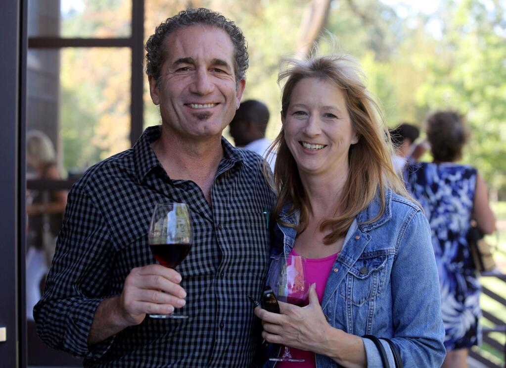 Sal Taormina, left, and Paula Peterson, right, during the 'Love of the Land,' dinner and awards ceremony held at Richard's Grove & Saralee's Vineyard on Slusser Road, Thursday, July 16, 2015. (Crista Jeremiason / The Press Democrat)
