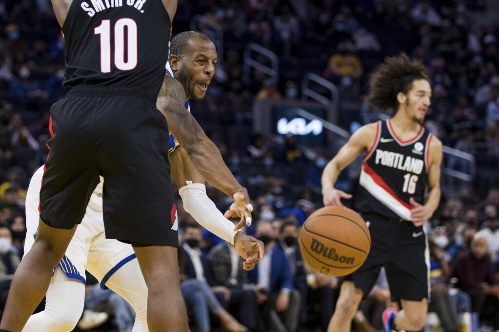 Golden State Warriors forward Andre Iguodala, right, is blocked by Portland Trail Blazers guard Dennis Smith Jr. (10) in the second half of a preseason NBA basketball game in San Francisco, Friday, Oct. 15, 2021. The Warriors won 119-97. (AP Photo/John Hefti)