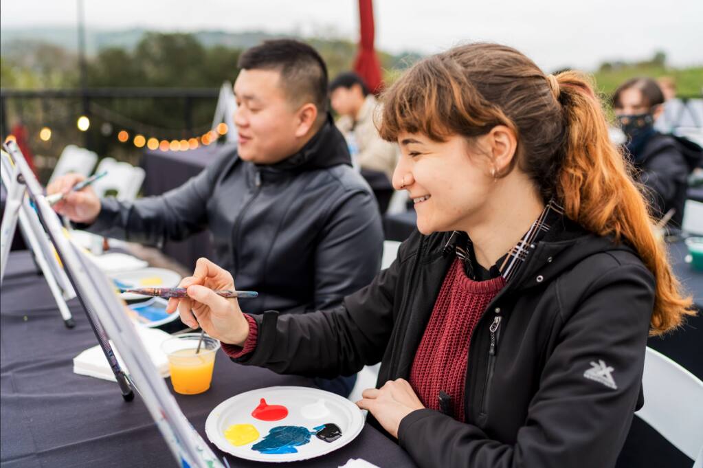 Jerry Wei and Madeleine Karydes of Empowerly concentrate on their paintings during a retreat in Napa. (courtesy of Empowerly)