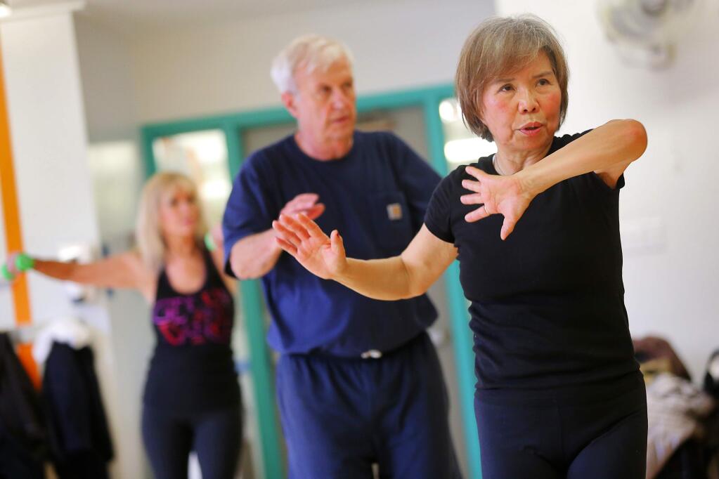 Sookbin Choi, 67, works out in the Stay Fit Forever exercise class at the YMCA in Santa Rosa, on Monday, March 21, 2016. (Christopher Chung / The Press Democrat)