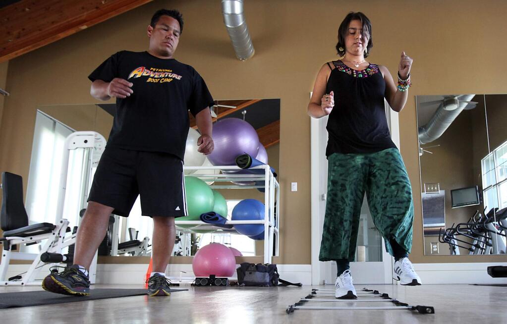 Personal trainer Jayme Larson works with Julia Bertoli who suffered brain damage and other injuries after she was hit by a car while walking in a Sebastopol crosswalk in July 2009. (PD FILE, 2010)