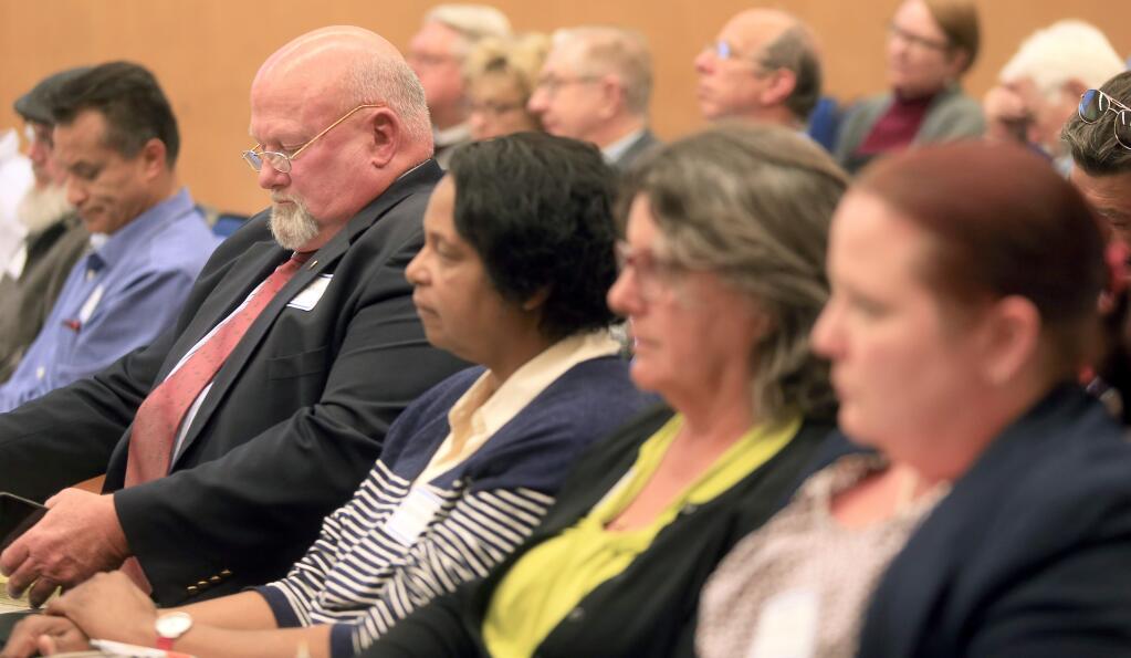 Eric Koenigshofer of the Community and Law Enforcement Task Force, left, and fellow task force members, Evelyn Cheatham, Lynn King and Amber Twitchell prepare for the unveiling of the panel's findings during the Board of Supervisors meeting in Santa Rosa on Tuesday, May 12, 2015. (KENT PORTER/ PD)