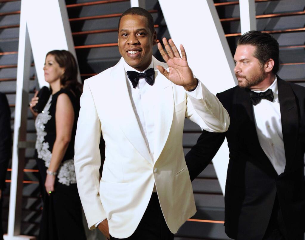 FILE - In this Feb. 23, 2015 file photo, Jay-Z arrives at the 2015 Vanity Fair Oscar Party in Beverly Hills, Calif. Tidal, the streaming service co-owned by Jay Z, Rihanna, Madonna and other artists, is inviting more performers to join the company and earn equity.Senior executive Vania Schlogel said late Tuesday, March 31, that Tidal welcomes more acts to join and said the current owners ìhave equal ownership and majority ownership in the company.î (Photo by Evan Agostini/Invision/AP, File)