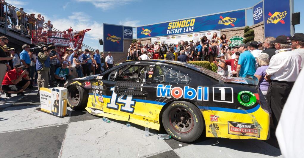 Julie Vader/Special to the Index-TribuneTony Stewart's Chevrolet is a bit beat up, but still makes it to Victory Lane at the Toyota/SaveMart 350 at Sonoma Raceway, Sunday, June 26.