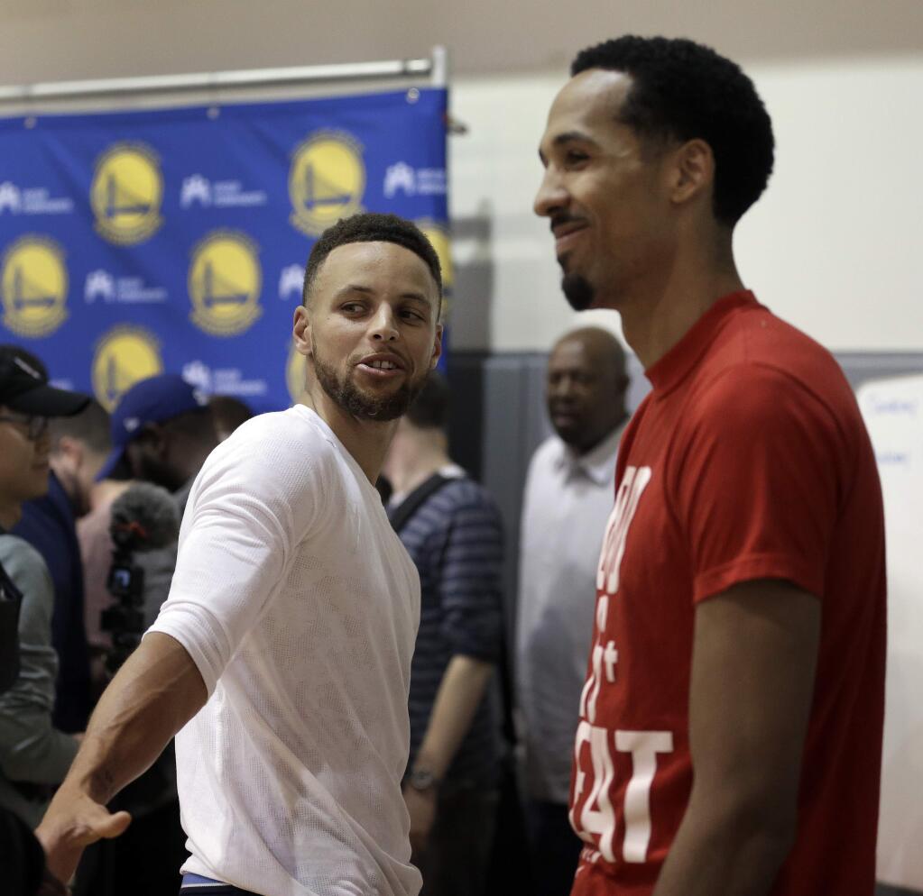 The Golden State Warriors' Stephen Curry, left, and Shaun Livingston speak with reporters during a news conference Wednesday, June 14, 2017, in Oakland. The Warriors won the NBA championship over the Cleveland Cavaliers earlier in the week. (AP Photo/Ben Margot)