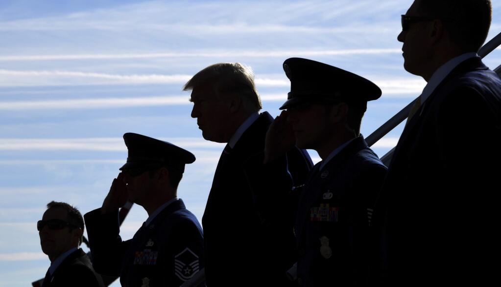President Donald Trump walks down the steps of Air Force One at John F. Kennedy International Airport in New York, Saturday, Dec. 2, 2017. Trump is in New York to attend a series of fundraisers. (AP Photo/Susan Walsh)