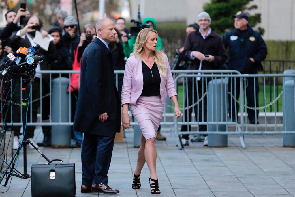 FILE - In this April 16, 2018, file photo, porn actress Stormy Daniels, accompanied by her attorney, Michael Avenatti, left, leaves federal court, in New York. (AP Photo/Seth Wenig, File)