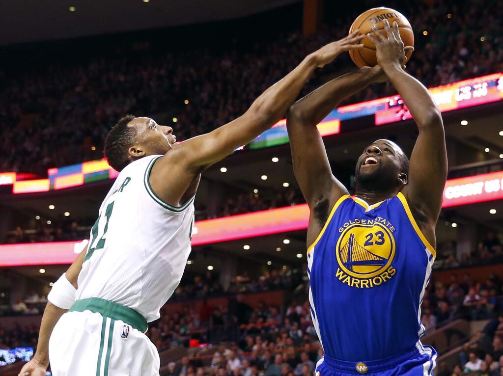 Golden State Warriors' Draymond Green (23) has his shot blocked by Boston Celtics' Evan Turner during the first quarter of an NBA basketball game in Boston, Sunday, March 1, 2015. (AP Photo/Winslow Townson)
