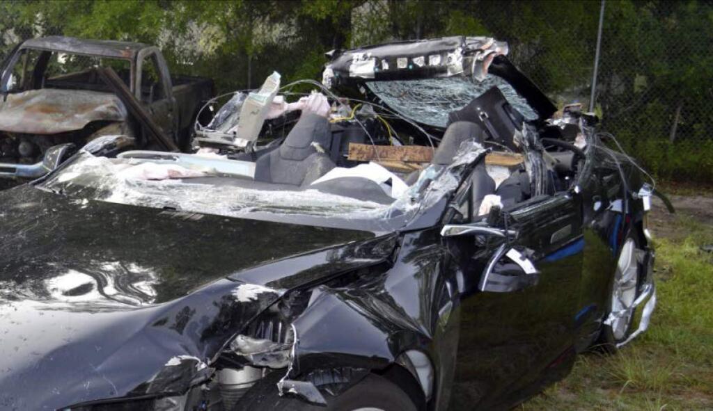 FILE - In this photo provided by the National Transportation Safety Board via the Florida Highway Patrol, a Tesla Model S that was being driven by Joshua Brown, who was killed when the Tesla sedan crashed while in self-driving mode on May 7, 2016. A source tells The Associated Press that U.S. safety regulators are ending an investigation into a fatal crash involving electric car maker Tesla Motors' Autopilot system without a recall. The National Highway Traffic Safety Administration scheduled a call Thursday, Jan. 19, 2017, about the investigation. (NTSB via Florida Highway Patrol via AP, File)