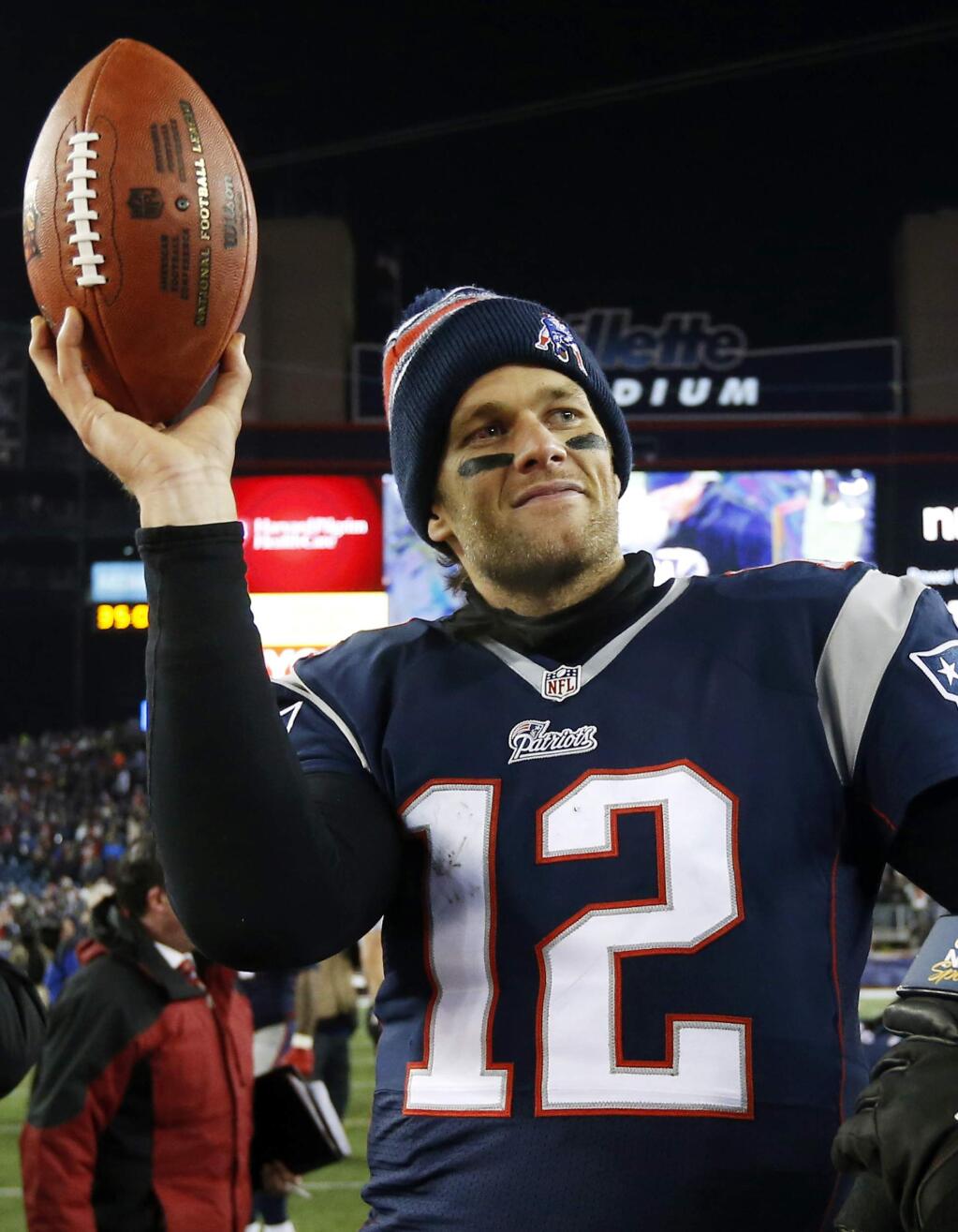 FILE - In this Jan. 10, 2015, file photo, New England Patriots quarterback Tom Brady holds up the game ball after an NFL divisional playoff football game against the Baltimore Ravens in Foxborough, Mass. A federal appeals court has ruled, Monday, April 25, 2016, that New England Patriots Tom Brady must serve a four-game 'Deflategate' suspension imposed by the NFL, overturning a lower judge and siding with the league in a battle with the players union. (AP Photo/Elise Amendola, File)