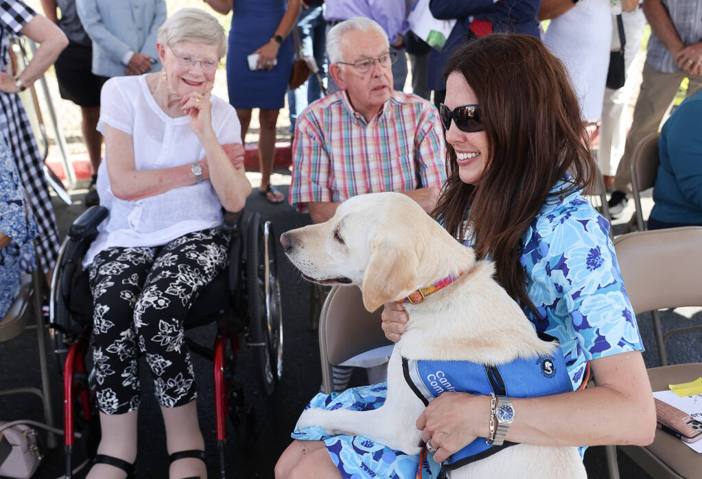 Michelle Ludwig and her Canine Companions assistance dog, Pam, attend the groundbreaking ceremony for the new Canine Health & Wellness Center at the Canine Companions Jean and Charles Schulz Campus in Santa Rosa on Friday, June 10, 2022. (Christopher Chung / The Press Democrat)