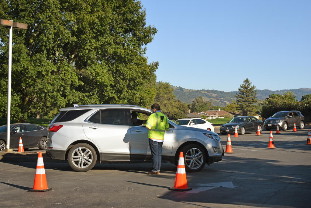PG&E setup a check-in to help coordinate gas restoration for residents in the parking lot of the Valley of the Moon Club after mandatory evacuation orders were lifted in Oakmont Village of Santa Rosa, Calif. on Sunday, October 4, 2020.(Photo: Erik Castro/for The Press Democrat)