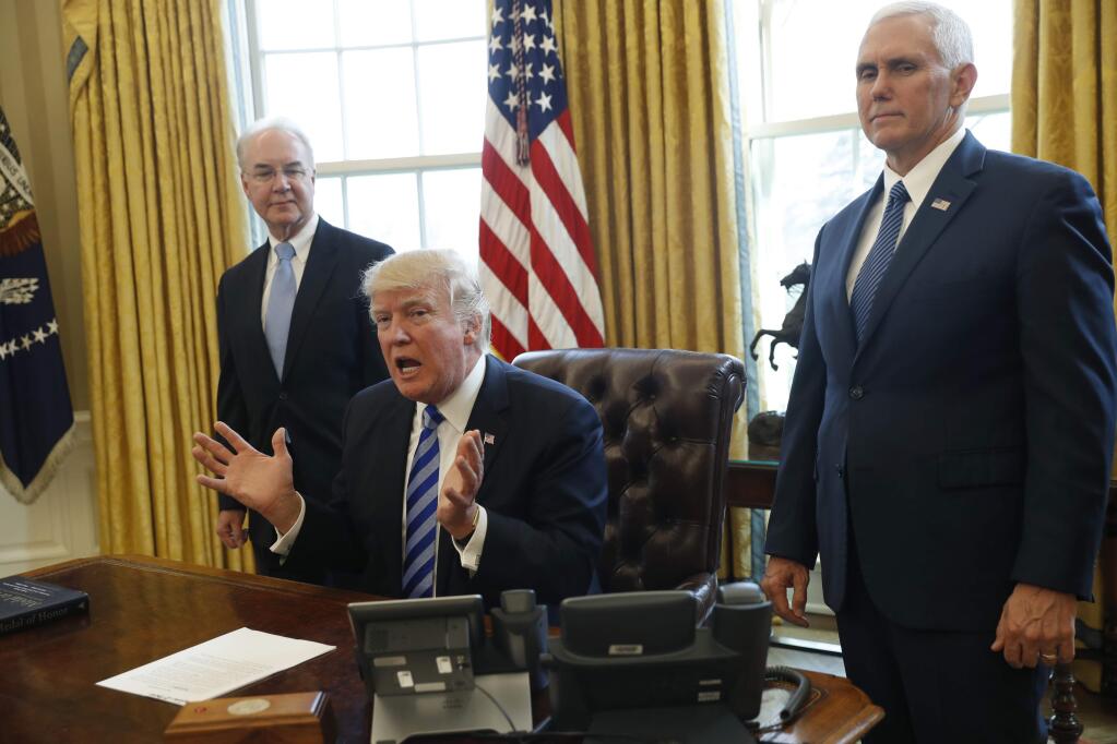 President Donald Trump, flanked by Health and Human Services Secretary Tom Price, left, and Vice President Mike Pence, meets with members of the media regarding the health care overhaul bill, Friday, March 24, 2017, in the Oval Office of the White House in Washington. (AP Photo/Pablo Martinez Monsivais)