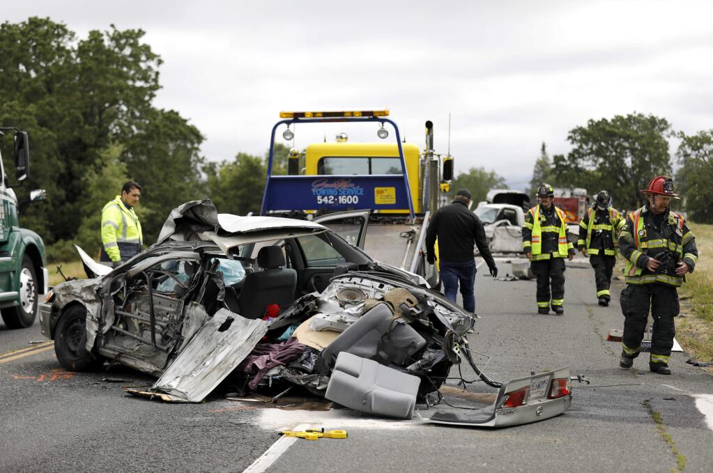 Santa Rosa firefighters work at the scene of a two-vehicle accident on Highway 12 in Santa Rosa on Monday, May 20, 2019. (BETH SCHLANKER/ PD)