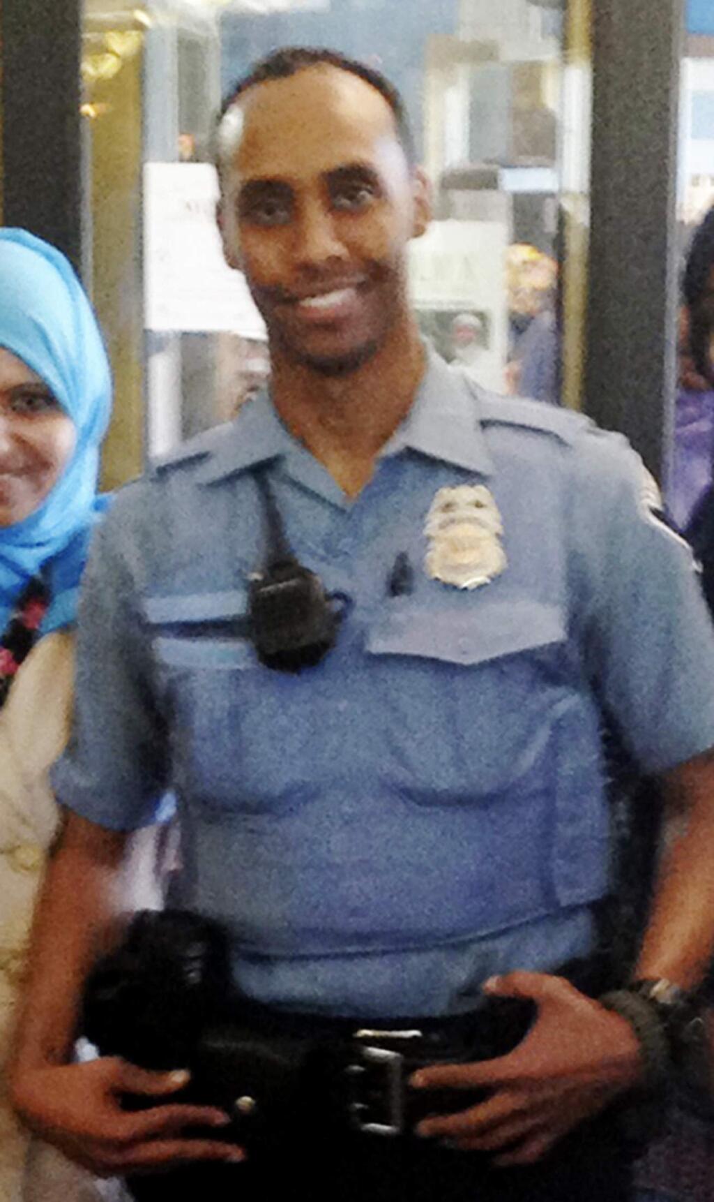 FILE - In this May 2016 file photo provided by the City of Minneapolis, police Officer Mohamed Noor poses for a photo at a community event welcoming him to the Minneapolis police force. Noor, a Minneapolis police officer who shot and killed an Australian woman in July 2017, turned himself in Tuesday, March 20, 2018, after a warrant was issued for his arrest, but the nature of the charges against him were not immediately known. (City of Minneapolis via AP, File)