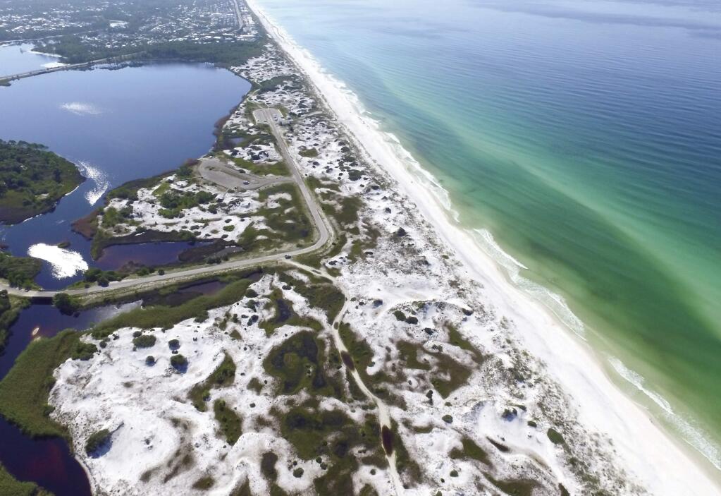 This Aug. 1, 2018, aerial photo made available by the Florida Department of Environmental Protection shows Grayton Beach State Park in Santa Rosa Beach, Fla. The beach earned the first spot of top U.S beaches according to Florida International University professor Stephen Leatherman. The beach was chosen in part because of its sugar-white sand and its clear, emerald-green water. (Running Man Pictures/Courtesy of Florida Department of Environmental Protection via AP)