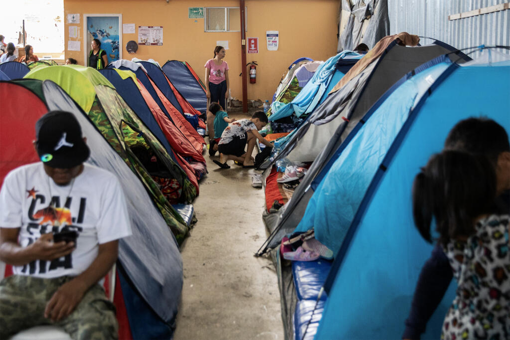 A group of migrants at Moviemiento Juventud 2000, a shelter in Tijuana, on July 26, 2023. Photo by Adriana Heldiz, CalMatters