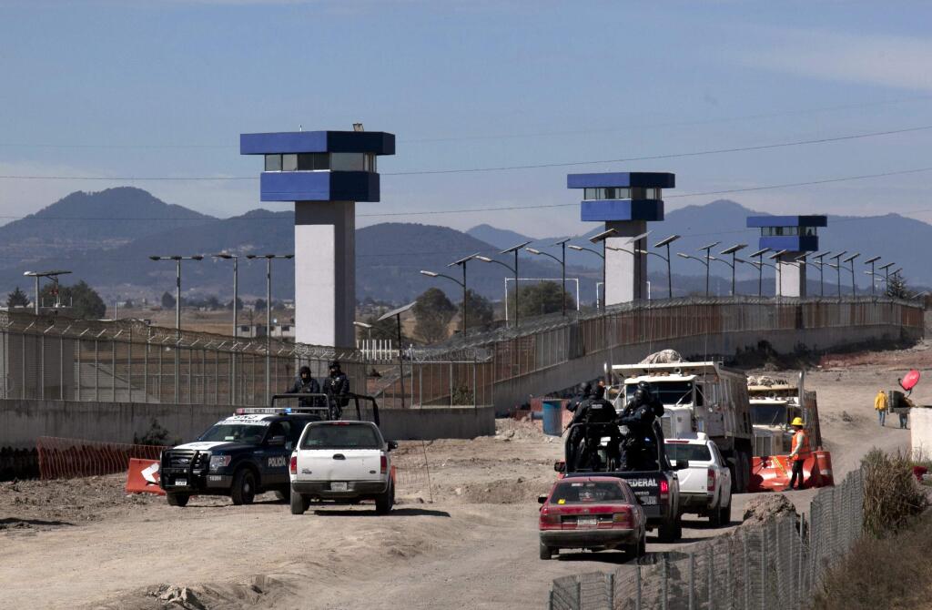 Federal Police patrol on the perimeters of the Altiplano maximum security prison in Almoloya, west of Mexico City, Saturday, Jan. 9, 2016, where Joaquin 'El Chapo' Guzman, head of the Sinaloa drug cartel, is being held after his recapture on Friday. Guzman was sent back to the maximum-security prison from where he escaped last July 11 through an elaborate tunnel that was dug to shower stall. (AP Photo/Marco Ugarte)