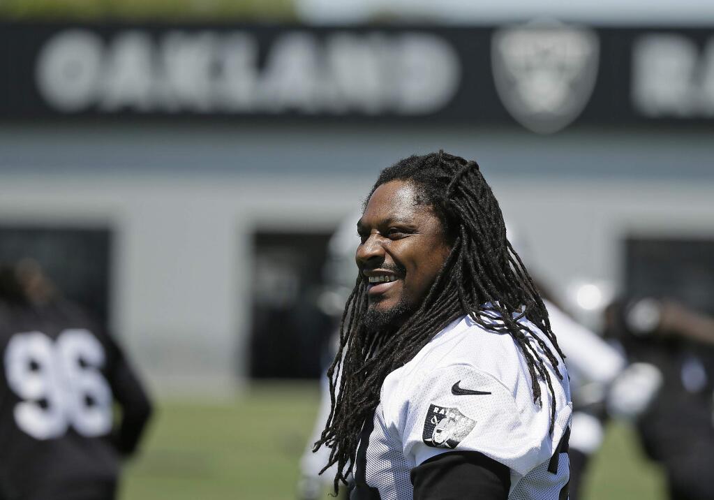 In this May 23, 2017, file photo, Oakland Raiders running back Marshawn Lynch stretches during practice in Alameda. (AP Photo/Eric Risberg, File)
