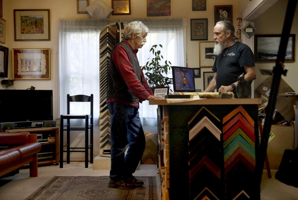 PHOTO: 1 by BETH SCHLANKER / The Press Democrat -Professional Framing Services owner John Allred, right, talks with customer Lenny Miller who was picking up an order earlier this month at the shop in Cotati.