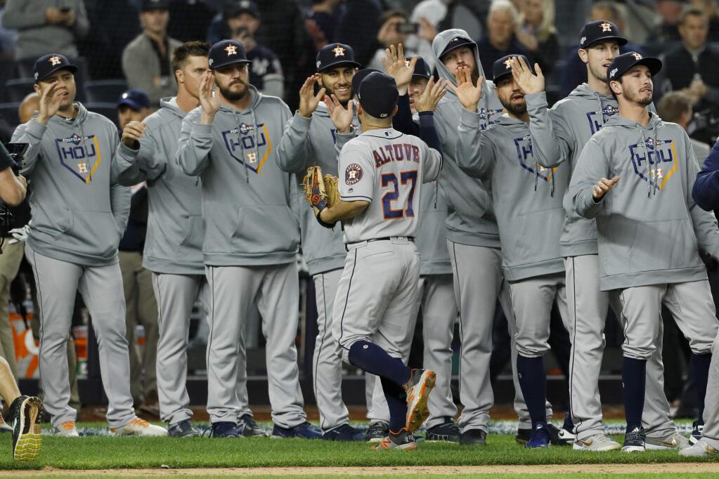 Houston Astros second baseman Jose Altuve celebrates with teammates after their 4-1 win against the New York Yankees in Game 3 of baseball's American League Championship Series Tuesday, Oct. 15, 2019, in New York. (AP Photo/Matt Slocum)